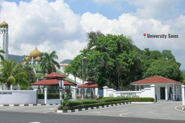 Universiti Sains Malaysia (USM) campus, showcasing modern architecture surrounded by lush greenery and students walking on the campus grounds.