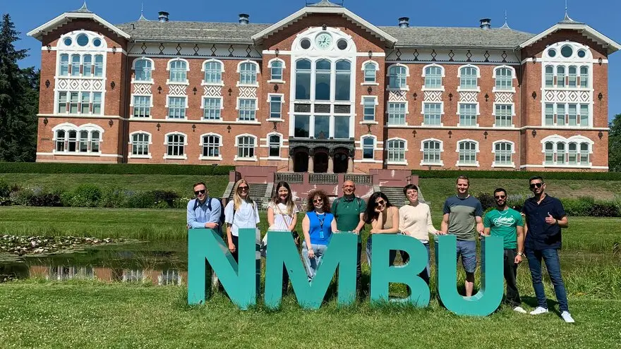 Historic main building of NMBU surrounded by greenery in Ås, Norway.

