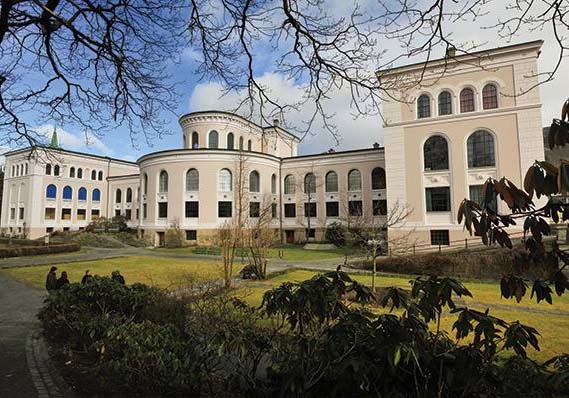 University of Bergen campus with historic buildings and surrounding Bergen mountains.